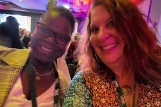 Dr. Abigail Joseph and Dr. Sarah Jefferis in front of stage smiling together