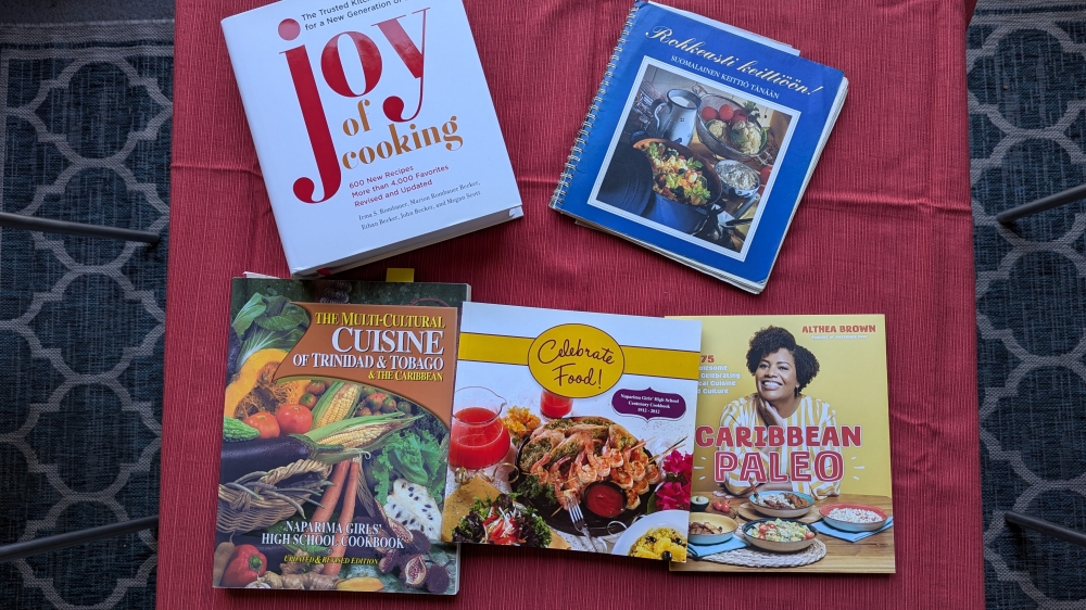 5 cookbooks on a table: Caribbean, Finnish, and Joy of Cooking