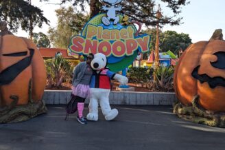 Dr Abigail dressed in pink for breast cancer walk with Snoopy character