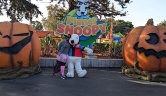 Dr Abigail dressed in pink for breast cancer walk with Snoopy character