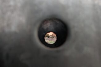 Looking at a street through a street sign pole