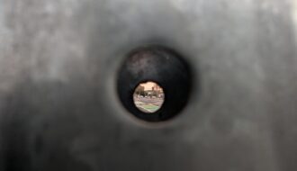 Looking at a street through a street sign pole
