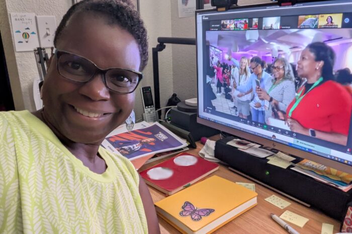 Dr Abigail working at her desk with Zoom window open to Speak & Write 2025
