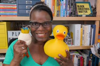 Dr. Abigail Joseph holding an idea stuffy and rubber duck.
